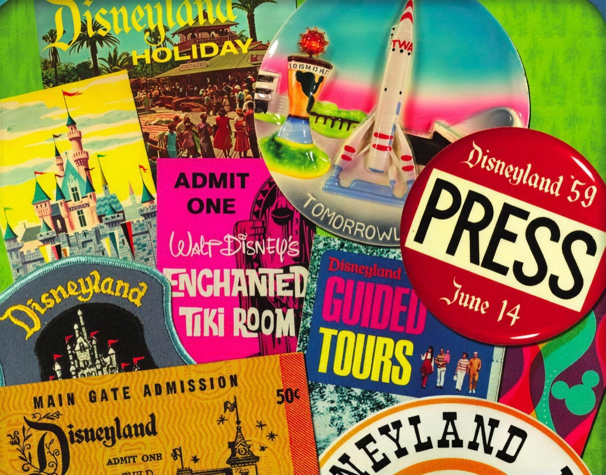 Vintage Disneyland park souvenirs — ticket books, Enchanted Tiki Room sign, 1959 press button and patches